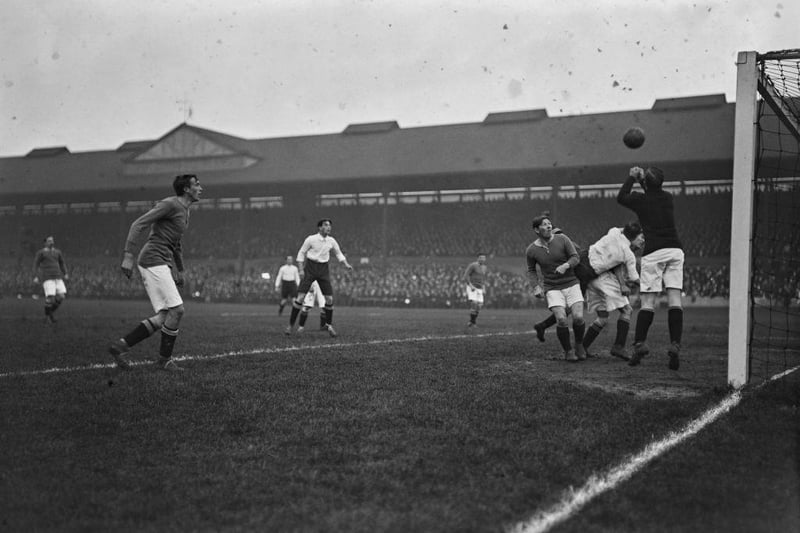 Chelsea goalkeeper Jim Molyneux punches away the ball during a match against Derby County at Stamford Bridge in November 15th 1913. Chelsea defeated Derby 2-1.