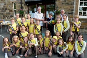 Leader of 1st Combs Brownies, Janet McNicol was presented with a community award by Chapel Parish Council in recognition of her dedication to the brownies for nearly five decades. She is pictured receiving her award from Cllr Liam McCarthy, chair of the parish council, and Cllr Peter Harrison in 2013