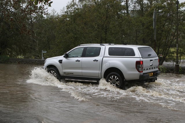 A driver battling the flooded roads caused by Storm Babet in Bakewell. Photo Jason Chadwick