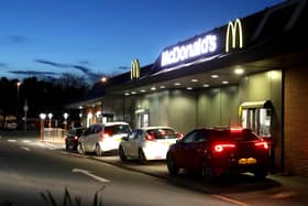 Customers queue at a McDonald's drive through restaurant (Photo by David Rogers/Getty Images).