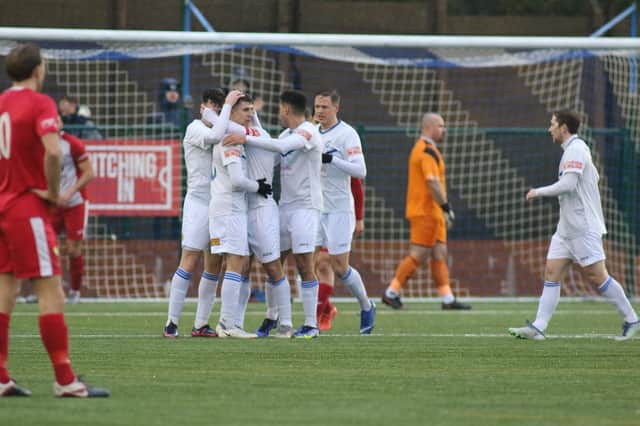 Buxton celebrate their opening goal in the 3-0 win over Ashton. It leaves them two points clear of Matlock at the top of the NPL table.