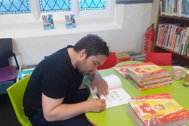 Oliver signing copies of Alfie's First Fight. Pic submitted