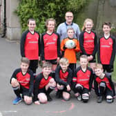 Buxworth Primary School pupils Georgie Garner, Lucy Allott, Ethan Moore, Evie Wilde, Louis Ecob, Tom Pollard, Henry Batt, Cavan Bowden, Dylan Moore and Finlay Rodgers model the new sports kit whihc has been sponsored by J S Burgess Engineering of Whaley Bridge