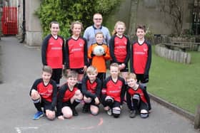 Buxworth Primary School pupils Georgie Garner, Lucy Allott, Ethan Moore, Evie Wilde, Louis Ecob, Tom Pollard, Henry Batt, Cavan Bowden, Dylan Moore and Finlay Rodgers model the new sports kit whihc has been sponsored by J S Burgess Engineering of Whaley Bridge