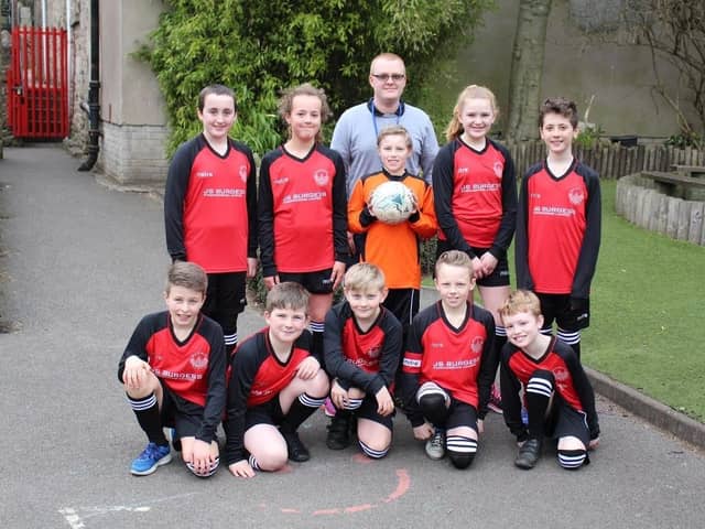 Buxworth Primary School pupils Georgie Garner, Lucy Allott, Ethan Moore, Evie Wilde, Louis Ecob, Tom Pollard, Henry Batt, Cavan Bowden, Dylan Moore and Finlay Rodgers model the new sports kit whihc has been sponsored by J S Burgess Engineering of Whaley Bridge