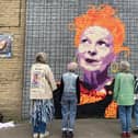 The ladies behind New Mills Fashion Week taking their message of sustainability to the Vivienne Westwood mural in Glossop. Photo submitted