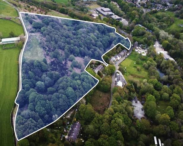 The site is bordered by homes and open farmland.