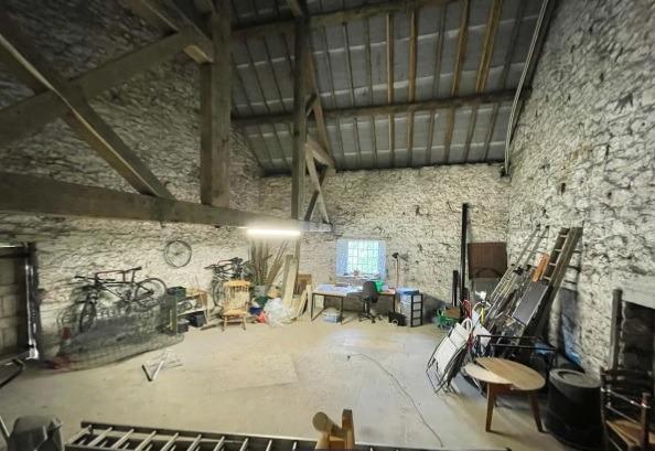 This barn, which is one of two attached to the house, has a vaulted ceiling. The second barn is accessed from the utility room.