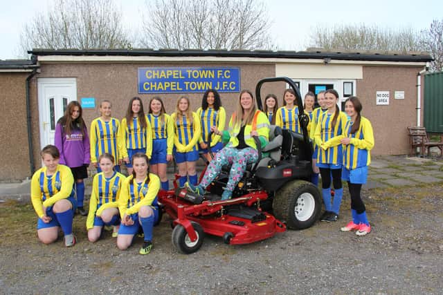 The Chapel Town Football Club girls? team show off the new mower to Tarmac Tunstead Cement Plant?s environmental coordinator Josie Shereston