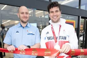 ParalympicsGB cyclist Lewis Stewart cut the all-important red ribbon, pictured alongside store manager Phil Welling. Photo Richard Grange/ UNP (United National Photographers)