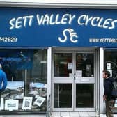 New Mills artist Clare Allan's artworks displayed in the window of Sett Valley Cycles.