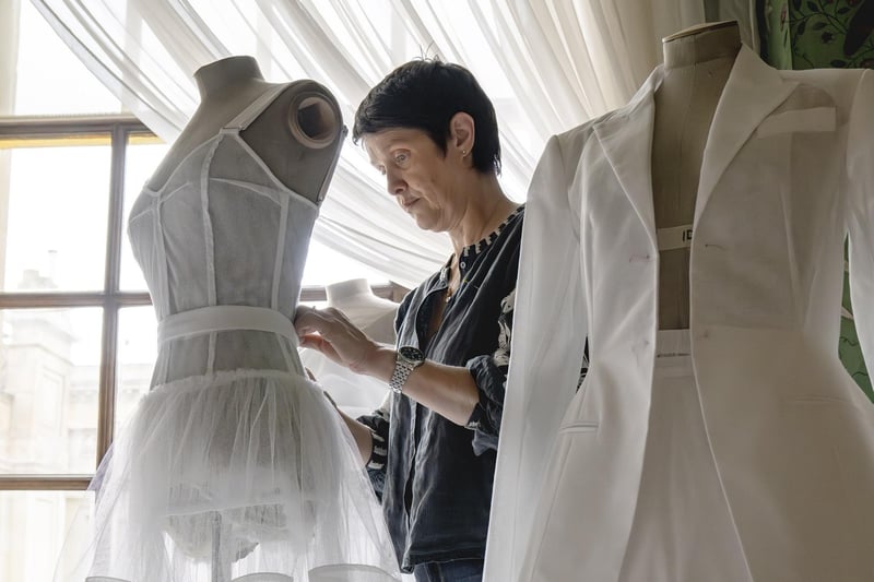 Susie Stokoe, textiles and seasonal programme curator at Chatsworth House, puts the final touches to the exhibits.