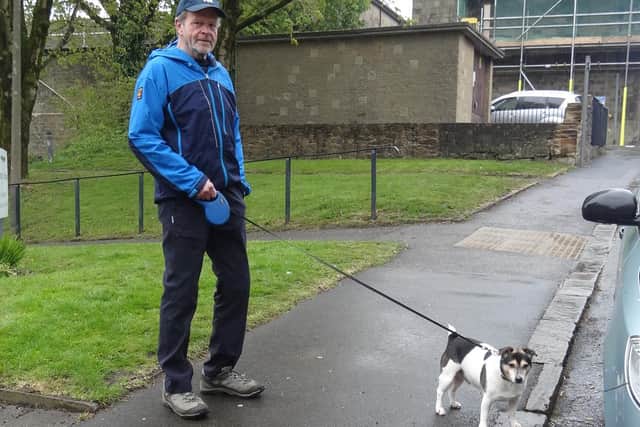 Blyth House community volunteer Jon Davey walks Stanley the dog, who belongs to a patient forced to self-isolate.