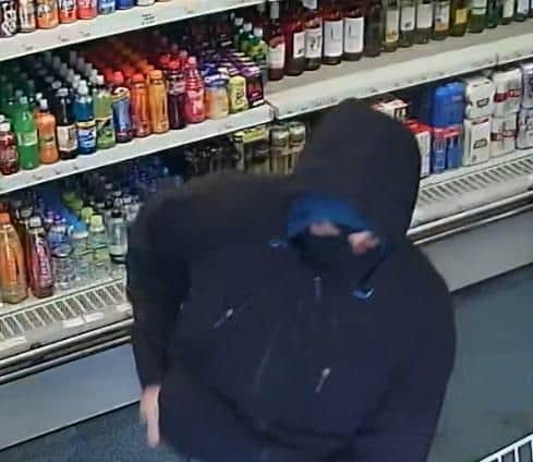 Police would like to speak to the man pictured in connection with a robbery at a New Mills shop