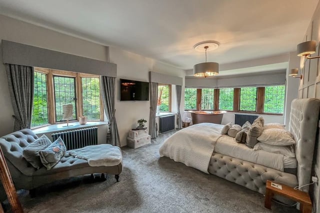 The master bedroom has a copper bath tub in the corner.