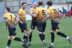 New Mills celebrate after Jake Walker (no.5) netted the equaliser. Photo: John Fryer.
