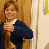 Jacob Hunt with the hair he had cut off and donated to the Little Princess Trust - a charity which makes wigs for poorly children