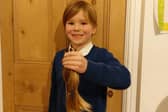 Jacob Hunt with the hair he had cut off and donated to the Little Princess Trust - a charity which makes wigs for poorly children