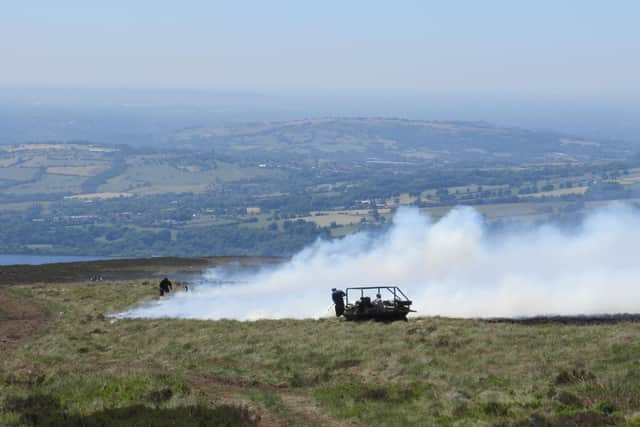 Gamekeepers fight the blaze with specialist fogging units. Photo -  Peak District Moorland Group