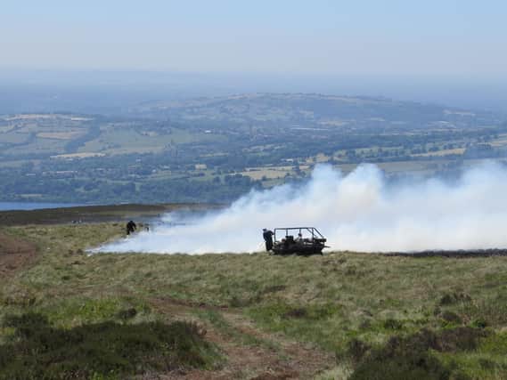 Gamekeepers fight the blaze with specialist fogging units. Photo -  Peak District Moorland Group