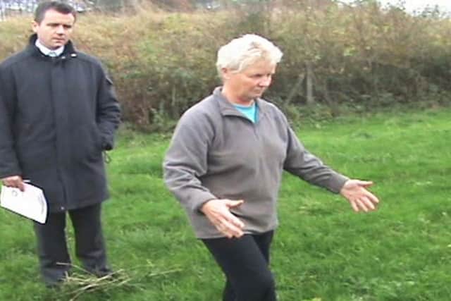 Janet Holt shows police where she claims she buried Fred's body in 2011. Photo - Raw Cut/ITV