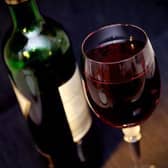 A bottle and glass of red wine.