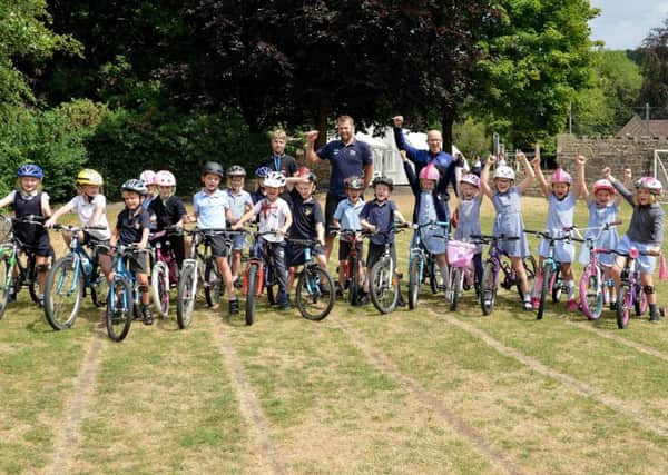 Whaley Bridge Primary School held a bike day with activites and coaching, pictured with Year 2 pupils are teacher Sam Emsley, cyclocross coach Matt Ellis and lead coach of GB MTB cycling team Simon Watts