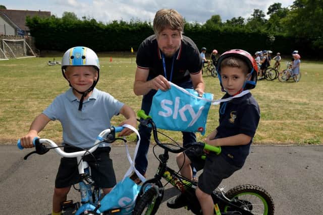 Whaley Bridge Primary School held a bike day with activites and coaching, winning a goodie bag are Connor, five and Rocco, six with teacher Sam Emsley