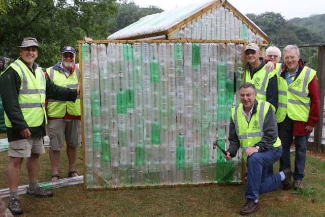 The Rotarians with a finished bottle wall raedy to into greenhouse