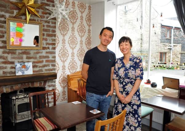 Jenny and Minhan in their Min's Tea House on Market Street, Buxton.
