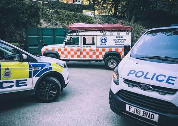 Police and rescue team vehicles at the scene. Pic: Derby Mountain Rescue