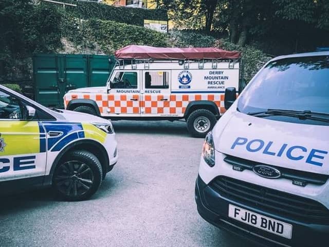 Police and rescue team vehicles at the scene. Pic: Derby Mountain Rescue