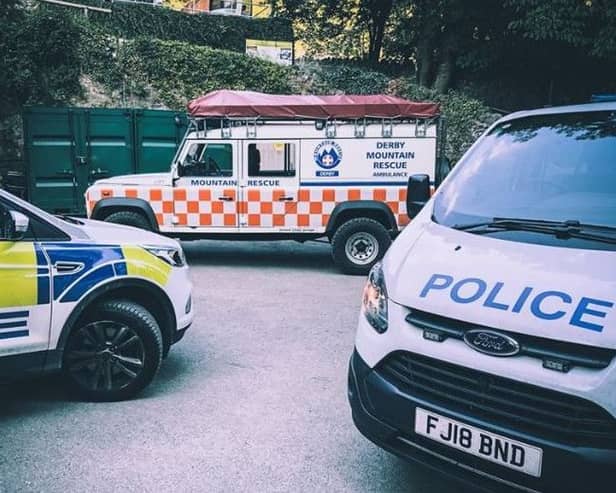 Police and rescue team vehicles at the scene. Pic: Derby Mountain Rescue