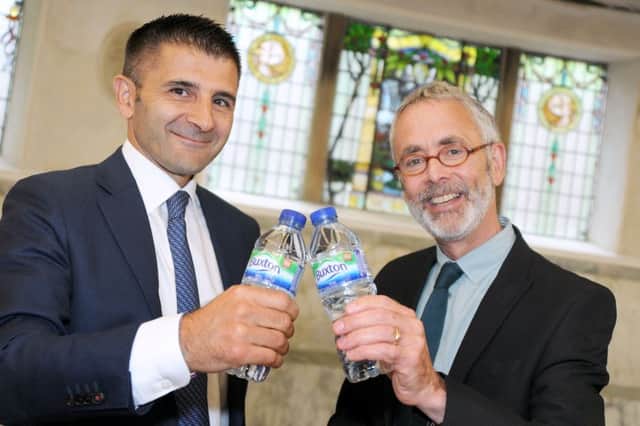 James Berrisford, the chairman of the Buxton Crescent Thermal Spa Heritage Trust, and Michel Beneventi, the Managing Director of Nestle Water join forces in the Pump Room on Tuesday.
