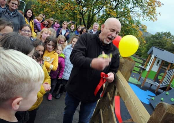 Phil Manford from the Chinley and Buxworth Community Centre, cuts the ribbon to officially open the new Chinley Playground.