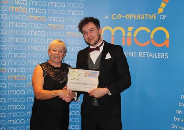 Joyce Hall receives her award from Mica Chief Executive Michael Ball.