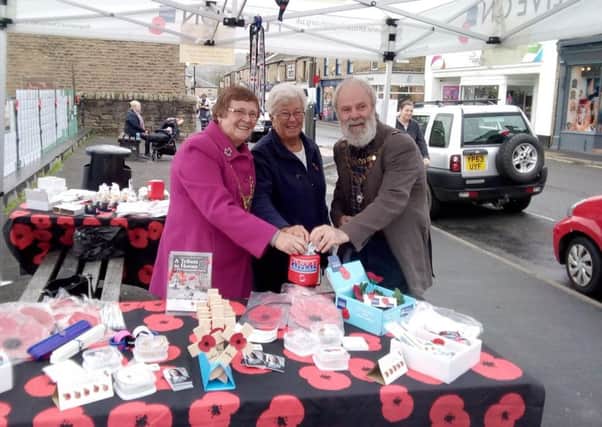Mayor of High Peak Linda Grooby, left, and New Mills council chairman Barry Bate made the first sale of this year's High Peak Poppy Appeal to Hague Bar resident Ann Rich.