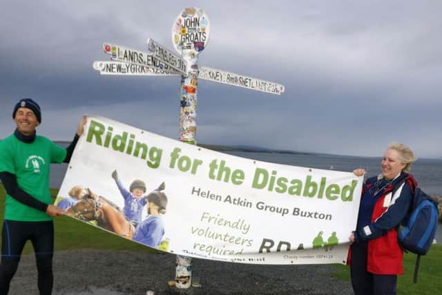 Steve Hunter is congratulated at the end of his marathon cycling challenge by Wendy Howe.