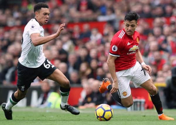 Liverpool's Trent Alexander-Arnold (left) and Manchester United's Alexis Sanchez battle for the ball.