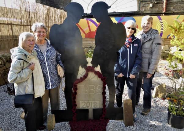 Sheila, Margaret, Susan and Kath are pictured with the Silent Soldiers and poppies.