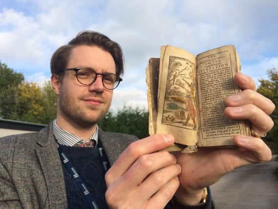 Jim Spencer with the ancient book found in Buxton. Photo: Hansons.
