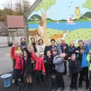 Whaley Bridge Primary School celebrate their new mural and climbing wall with artists Lyndsey Selley and Rob Wilson and guests from the PTA and Tesco.