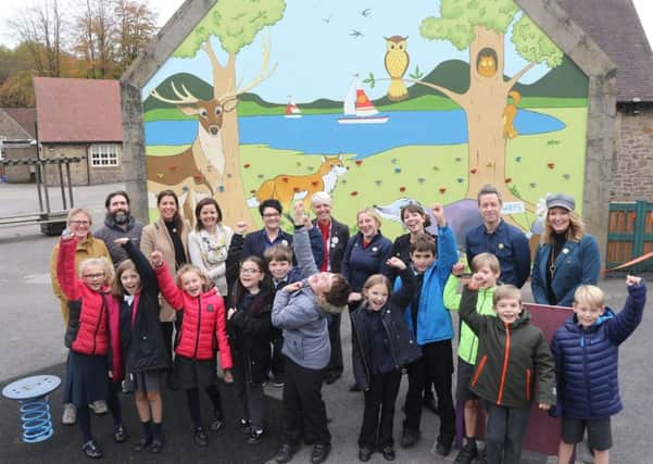 Whaley Bridge Primary School celebrate their new mural and climbing wall with artists Lyndsey Selley and Rob Wilson and guests from the PTA and Tesco.
