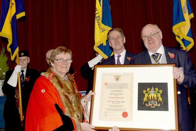 Bob Nicol, President of the Buxton branch of the Royal British Legion, receives the commemorative Freedom of the Borough scroll from High Peak Mayor Linda Grooby and council chief executive Simon Baker.