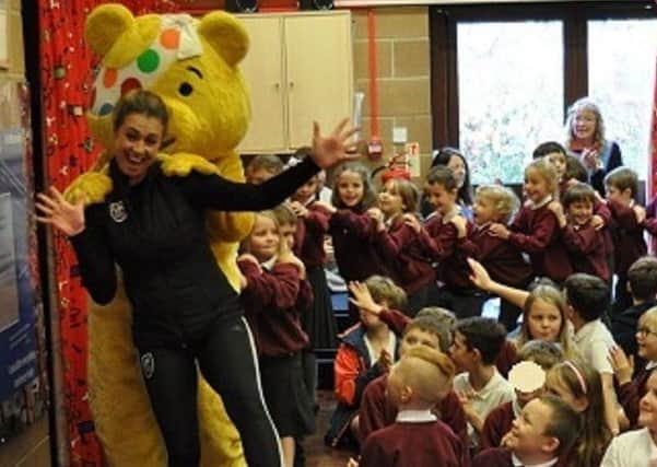 Pudsey Bear does the conga at Taxal & Fernilee Primary School in Whaley Bridge.
