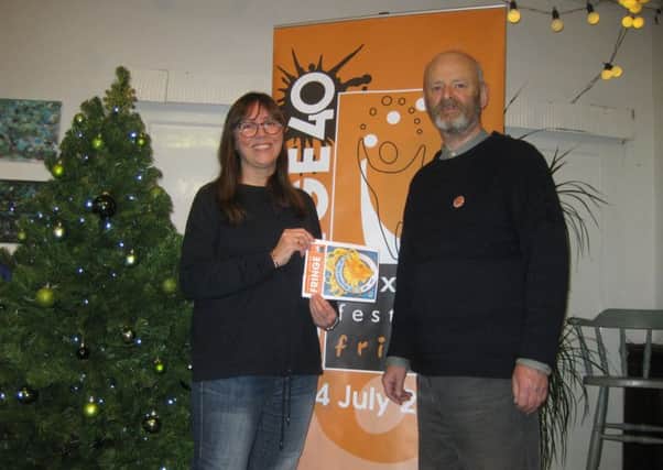 Catherine Webb with her winning artwork for the Fringe 2019 cover alongside Fringe chair Keith Savage.