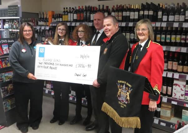 Burbage Band receive a cheque for Â£2654.98 to buy new instruments from the Co-op Local Community Fund.