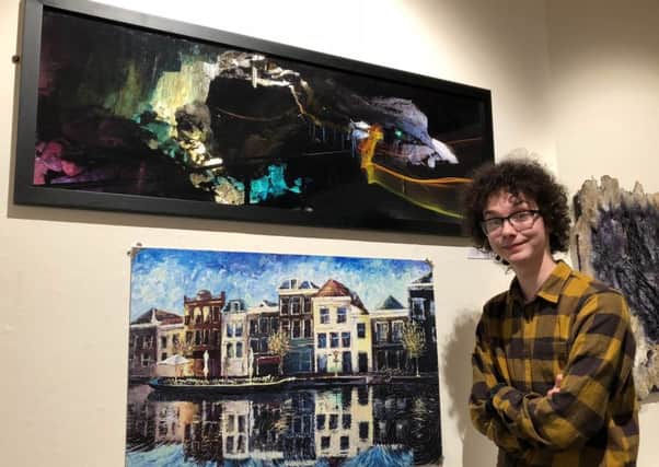 Austin with his photograph Spirit of the Cave. Photo courtesy of Explore Buxton.