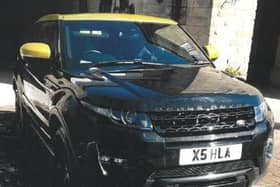 A stolen black Range Rover Evoque which has a yellow roof.