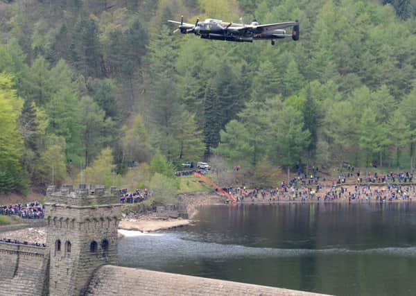 A Lancaster bomber flying over the Derwent Dam.